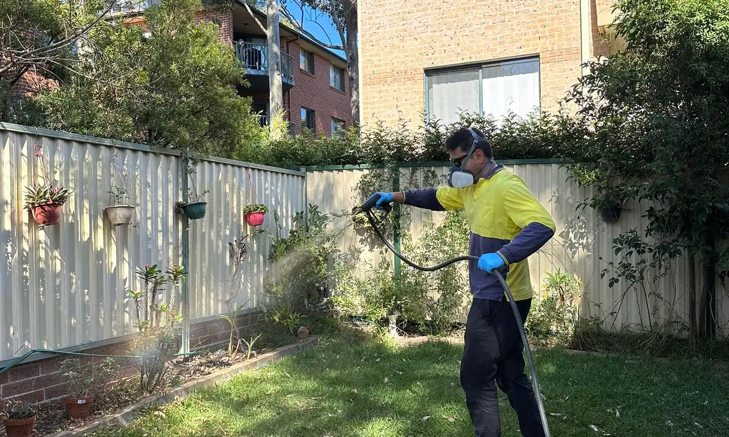 A Jashlin Pest Control technician treating a property, one of the people you'll meet
